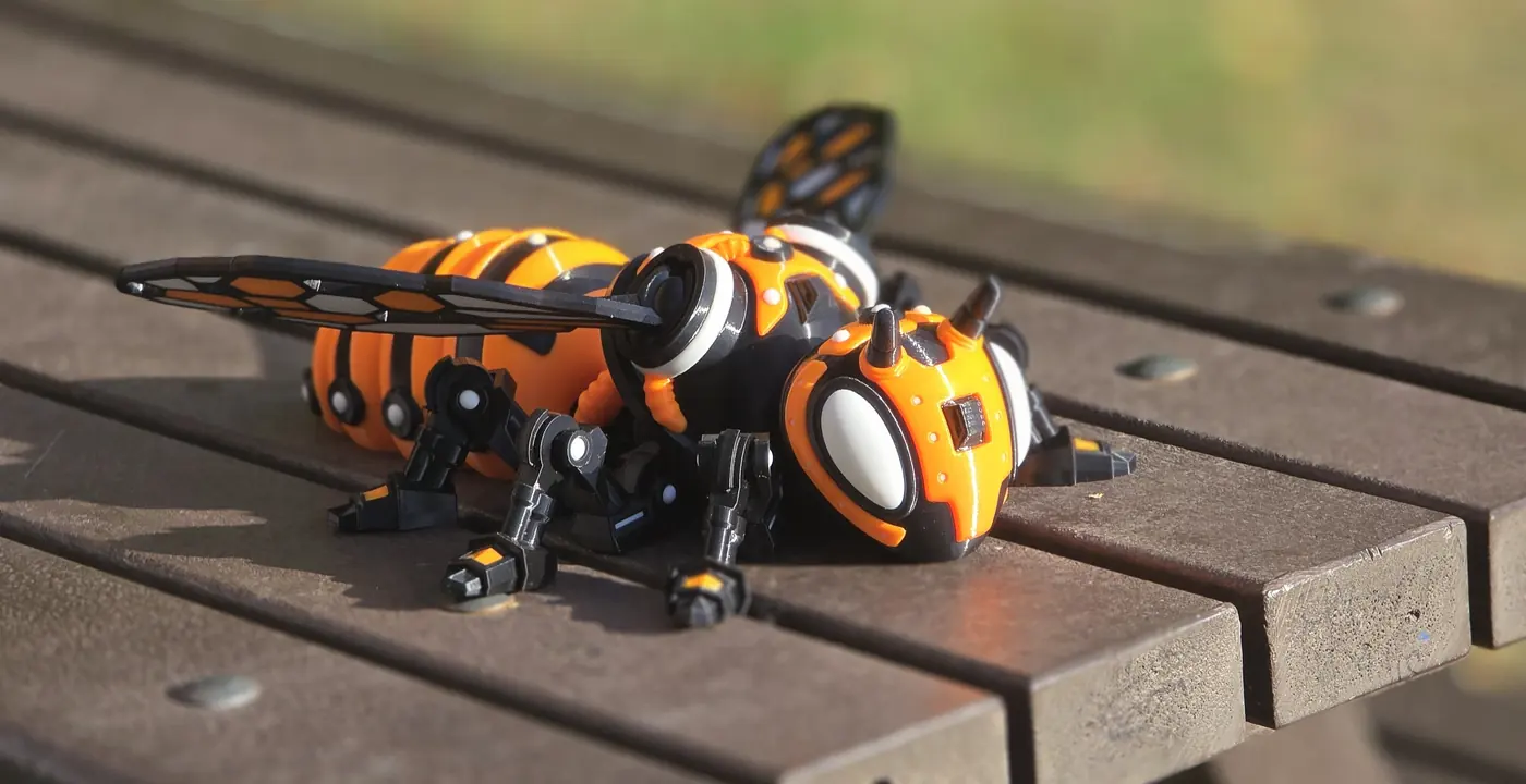 Orange and black articulated 3D-printed mechanical bee, nearly 450 mm long
